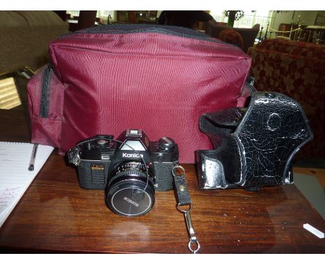 Konica camera with carry case, 55mm lens, various other accessories in carry case