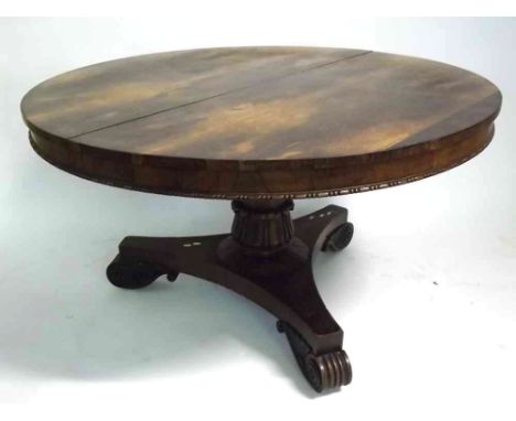 Early 19th century rosewood circular pedestal dining table, beaded lower frieze and raised on tripod base with scroll feet (a