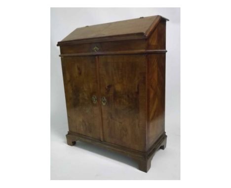 Small walnut slope fronted bureau fitted with two cupboard doors, raised on bracket feet with satinwood stringing (made from 