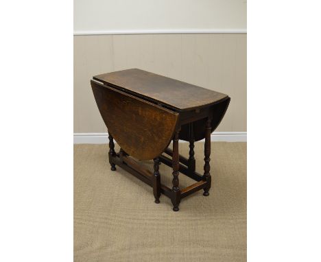 An early 18th Century oak oval Gate-leg Table fitted single drawer on baluster turned and square legs united by square stretc