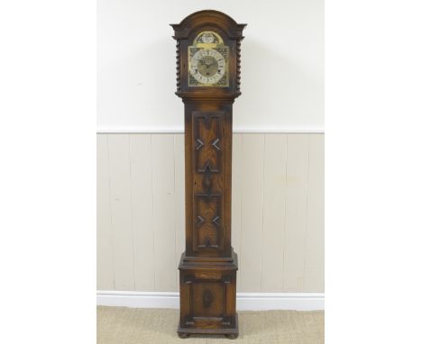 A 1920's oak cased Grandmother Clock with arched brass dial having silvered chapter ring, corner spandrels, three train strik