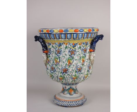 A late 19th Century or later Cantagalli type faience Urn with double mask and rope twist handles, the spiral moulded body dec