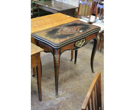 A 19th Century ebonised and tortoiseshell inlaid Card Table with shaped fold out top on sliding support action with ormolu mo