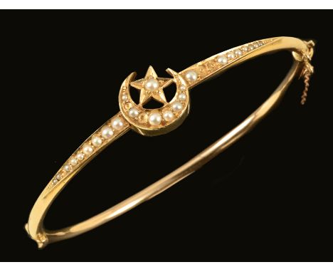 A Seed Pearl Hinged Bangle the front with star and crescent motif set graduated seed pearls throughout, stamped 15ct (lacks s