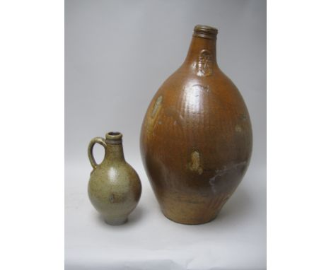 A large Bellarmine Flask with mask spout, loop handle and stamped $, 19in, and a smaller Flask, 9in, both A/F