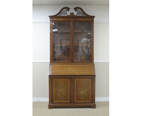 A marquetry inlaid mahogany Bureau Bookcase by Edwards and Roberts having pierced and carved swan neck pediment above a pair 