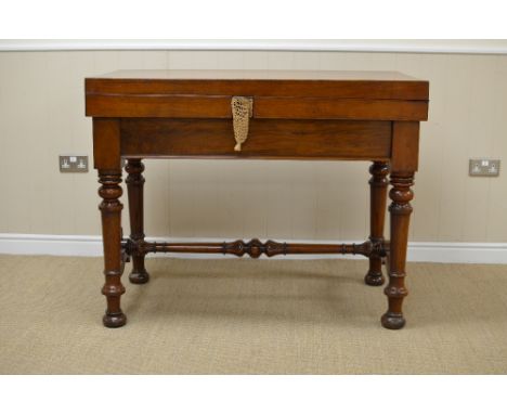 A Victorian walnut Bagatelle Table with cross-banded fold-over top enclosing baize lined interior with balls, cues and scoreb