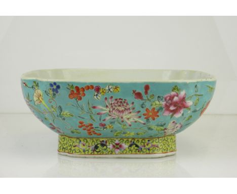 A Chinese turquoise ground famille rose porcelain offering Bowl, of square form, decorated with peony and other flowers on a 