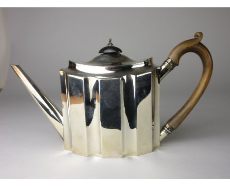 A George III silver Teapot of oval panelled form with wooden handle and finial, London 1792, maker: C.H.