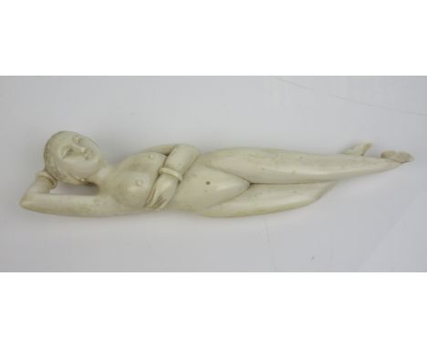 A Chinese ivory 'Doctors Model' reclining holding her hand behind her head, 9 1/4 in L