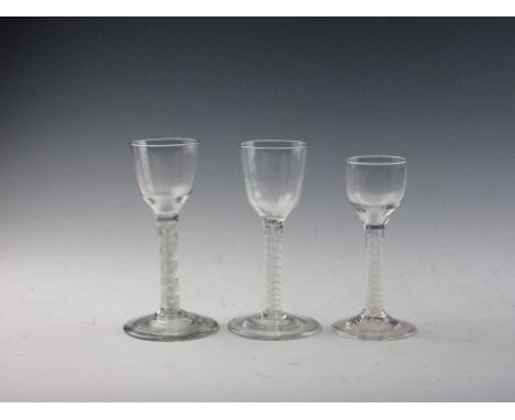 Three Georgian Wine Glasses, comprising a double series opaque twist with ogee bowl; double series opaque twist with moulded 