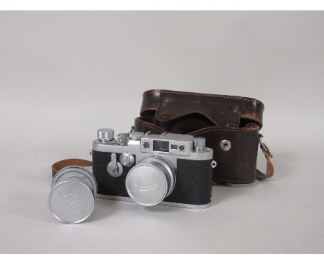 A Leica IIIg Camera in leather case, 1959, Nr 956217 with 3.5cm Wetzlar lens, additional 5cm Wetzlar lens and with accessorie