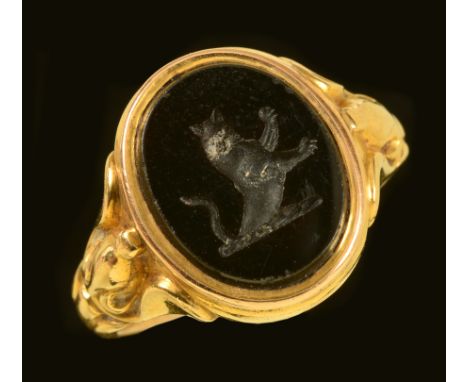 A Signet Ring set oval black onyx with intaglio carved seal stamped 18ct, ring size P