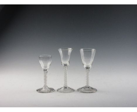 Three Georgian Wine Glasses, comprising a short double series opaque twist cordial with funnel bowl; a double opaque twist wi