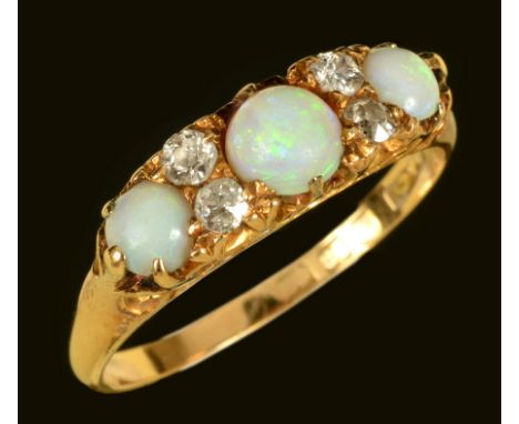 An Opal and Diamond Ring set three graduated round opal cabochons with pairs of old-cut diamonds between in 18ct gold, ring s