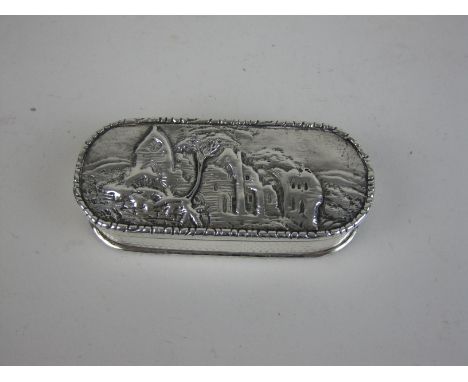 A 19th Century silver Snuff Box, the lid embossed with ruins, probably Dryburgh Abbey, Scotland, engine turning and vacant ca