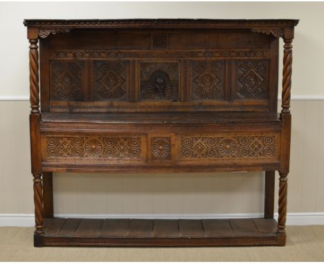 An antique oak Buffet with dentil frieze above leafage carved frieze bearing date 1603, central portrait panel depicting Eliz