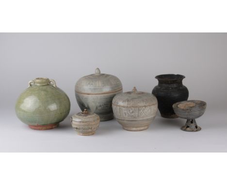 Six Thai pottery Vessels, including three 15th Century Swankalok Jars and Covers, a celadon globular flask, a blackware stem 