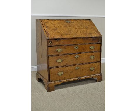 An 18th Century burr elm Bureau, the moulded fall revealing a stepped and welled interior of drawers and pigeon holes around 