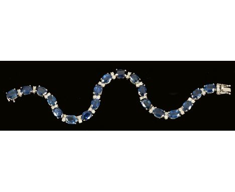 A Sapphire and Diamond Line Bracelet, each articulated link claw-set oval-cut sapphire, total sapphire weight 17.30ct, inters