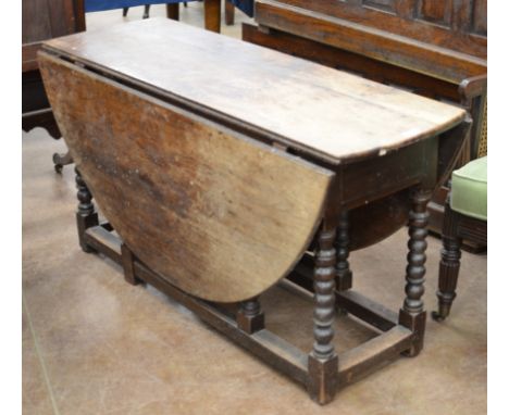 An 18th Century Gateleg Table, the twin flap oval top above a ring turned legs &amp; square stretchers 4ft 6ins x 5ft 2ins (m