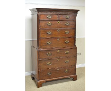A George III mahogany Chest on Chest with carved frieze fitted two short and six long drawers mounted upon ogee bracket feet,