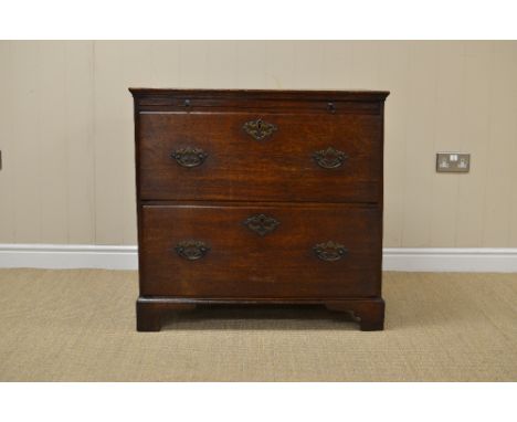 An 18th Century Bachelor's Chest in oak fitted brushing slide above two deep drawers on bracket feet, 2ft 9in