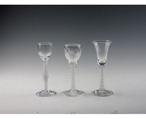 Three Georgian Wine Glasses, comprising a cordial with opaque twist swollen knop stem, a double series opaque twist stem with