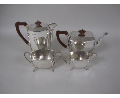 A George VI silver four piece Tea Service with Art Deco design on shaped feet, Sheffield 1947 and a pair of Sugar Tongs