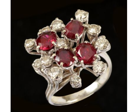 A Ruby and Diamond Cocktail Ring claw-set four oval-cut rubies interspersed with twelve brilliant-cut diamonds, ring size L 1