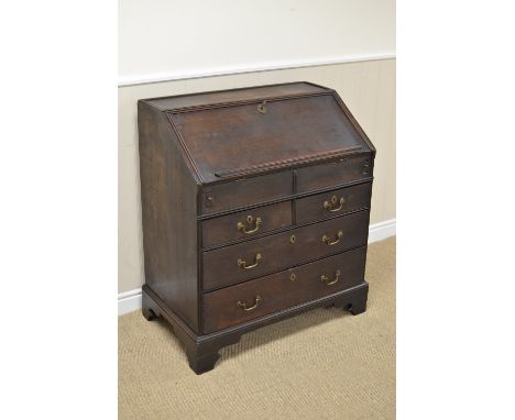 An early 18th Century oak Bureau with interior pigeon holes, small drawers and well, two short and two long drawers beneath o
