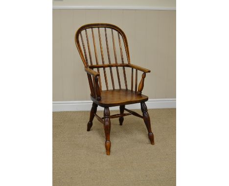 A 19th Century Windsor Elbow Chair with stick back, solid seat on turned legs united by H stretcher