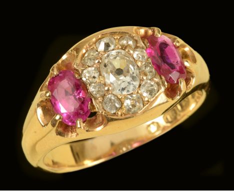 An early 20th Century Diamond and Ruby Ring pavé-set old-cut diamond within ten smaller old-cut diamonds between two old-cut 