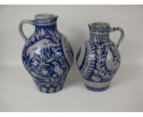 Two large Rheinish stoneware Ewers with scrgafitto decoration of hunting scenes with birds, animals, flowers and leafage, 17 