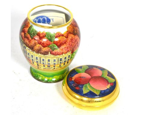 A Moorcroft enamel Pomegranate pattern trinket box together with a Moorcroft enamel vase decorated with Chatsworth House, 8cm