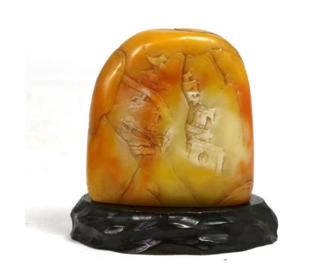 A Shoushan stone carving, of boulder form, carved in low relief with pagodas in landscape, 9cm high, bears collection label f