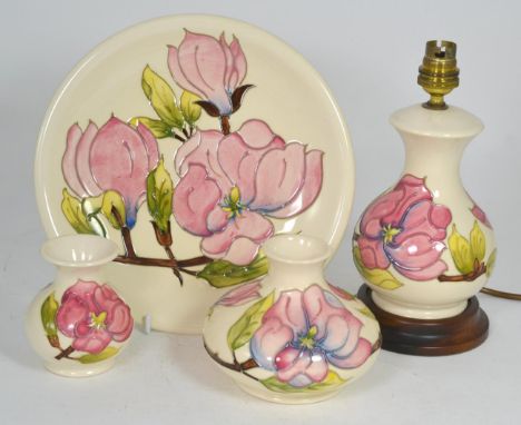 A group of Moorcroft Magnolia pattern pottery comprising: a table lamp, 24cm (including fittings); a small vase, 10cm; a larg