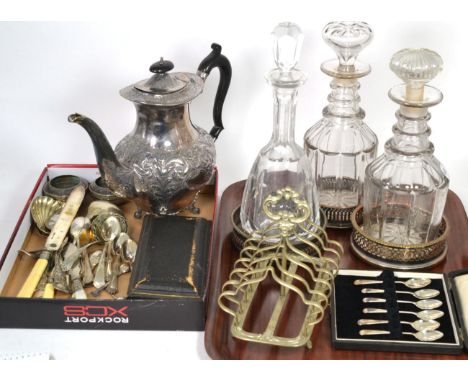 A quantity of silver flatware including spoons, toddy ladle, sugar tongs etc; three plated decanter stands; three glass decan