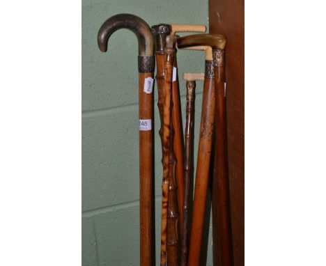 Four malacca walking sticks with horn and marine ivory handles and three bamboo walking sticks with mother of pearl, silver a