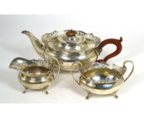 A three piece silver tea service, Alexander Clark, Birmingham 1923, oval with foliate pierced rim, on four pad supports, the 