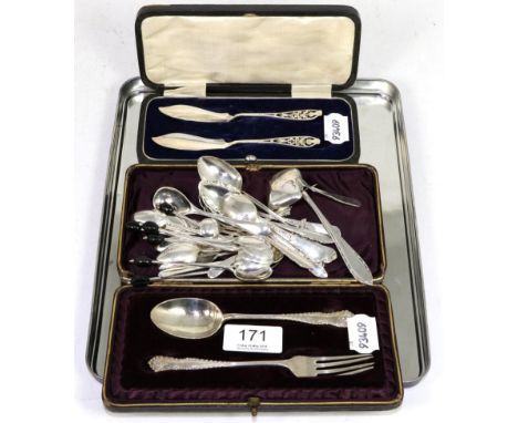 A cased pair of silver fish knives with pierced thistle terminals, a cased silver christening fork and spoon and a quantity o