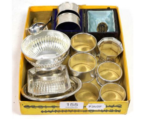 A cased pair of silver napkin rings, six other various silver napkin rings, two silver pin dishes, silver tongs, silver caddy