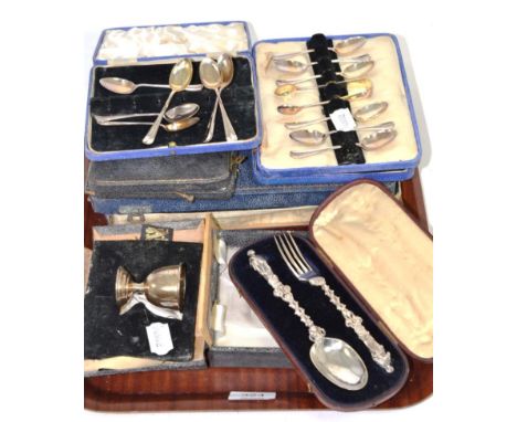 Three sets of silver teaspoons, a silver egg cup; a Victorian silver gospel spoon and fork cased; and a set of silver handled