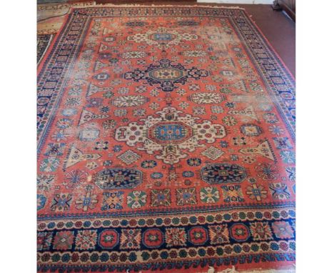 Caucasian carpet 20th centurydecorated with plant and floral patterns on an orange and blue background, wears365x250 cm.