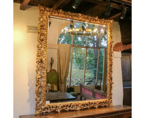 Large gilded wood rectangular mirror Italy, 20th centurycarved and perforated frame with rich plant and scroll motifs210x190 