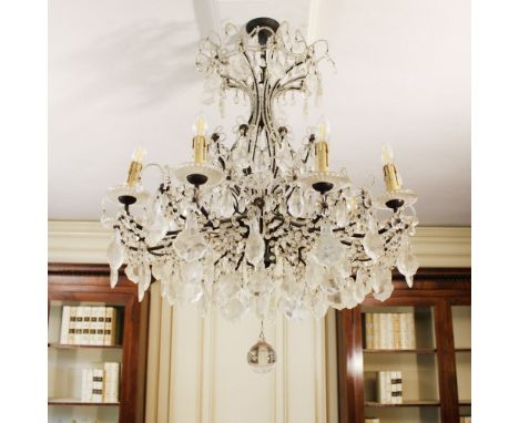 Ten-lights chandelier in bronze and glass Italy, 20th centuryshaped line structure decorated with pendants and glass elements