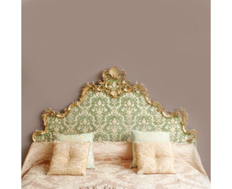 Headboard Italy, 19th-20th century.in golden wood and carved with floral, vegetal and opposite volutes motifs, partially cove