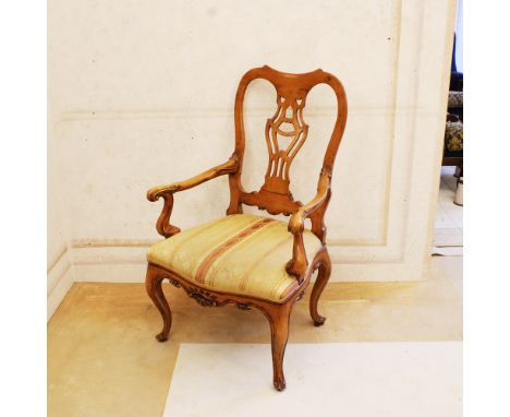 Maple wood armchair Italy, 20th centurystructure openworked and carved with vegetal and volute motifs, curly armrests, fabric
