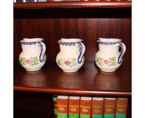 Three ceramic jugs Italy, 20th centurydecorated in polychrome with plant and floral motifs, shaped handlesh. 16 cm.