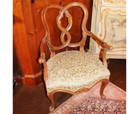 Walnut armchair Italy, 20th centuryshaped and carved structure with scroll motifs, fabric upholstered and covered seat93x70x5